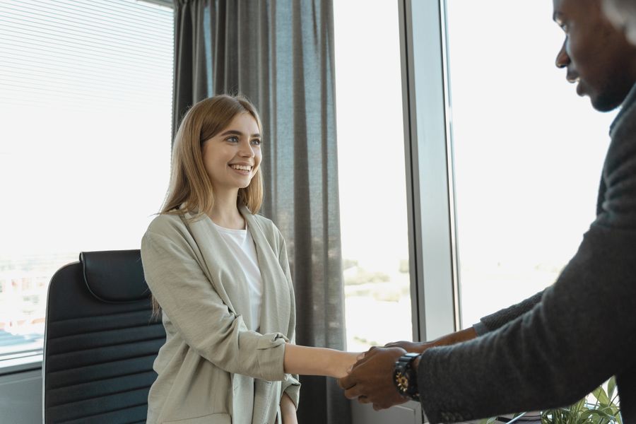 A candidate shaking hands with an interviewer after a job interview